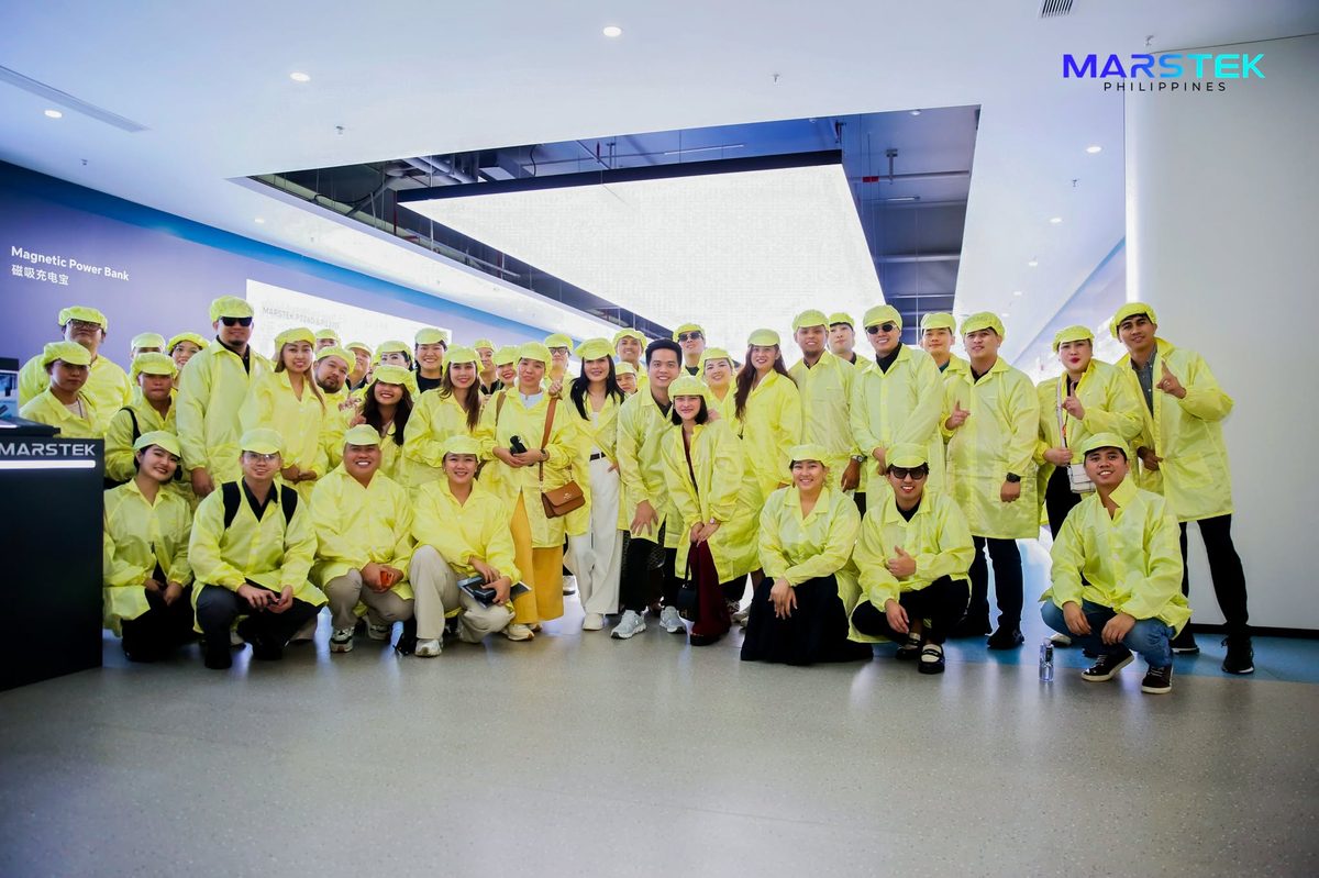 Visitors in the yellow coats and caps required inside Marstek's production area