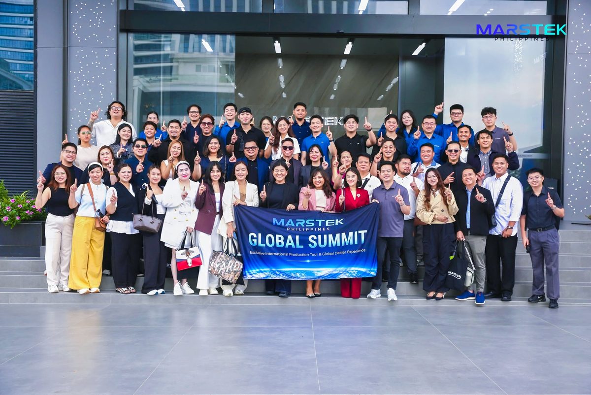 The group outside Marstek's building behind a Marstek Philippines Global Summit banner